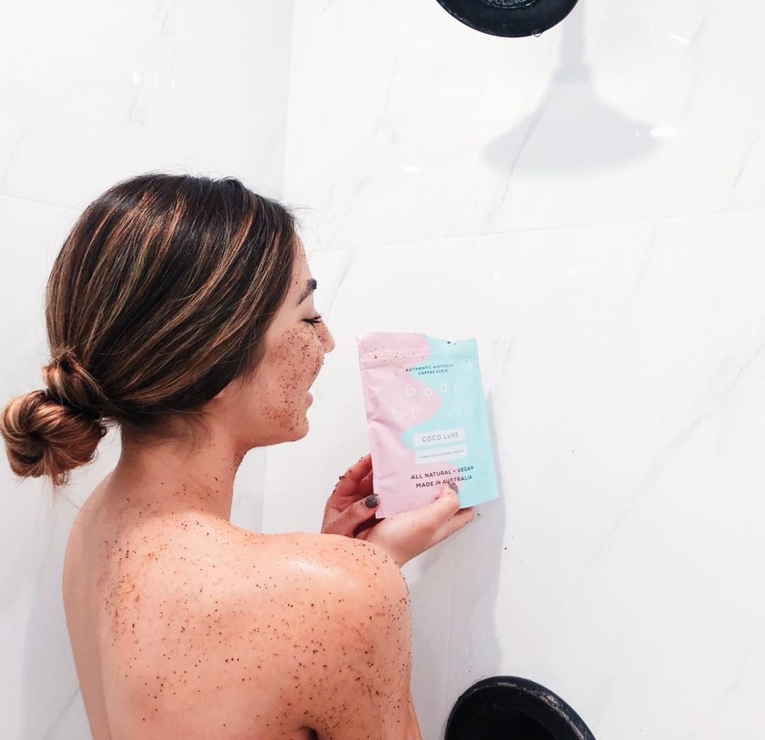 BodyBlendz coco luxe coffee scrub used in shower by model, natural exfoliating body scrub for smoother softer glowing skin