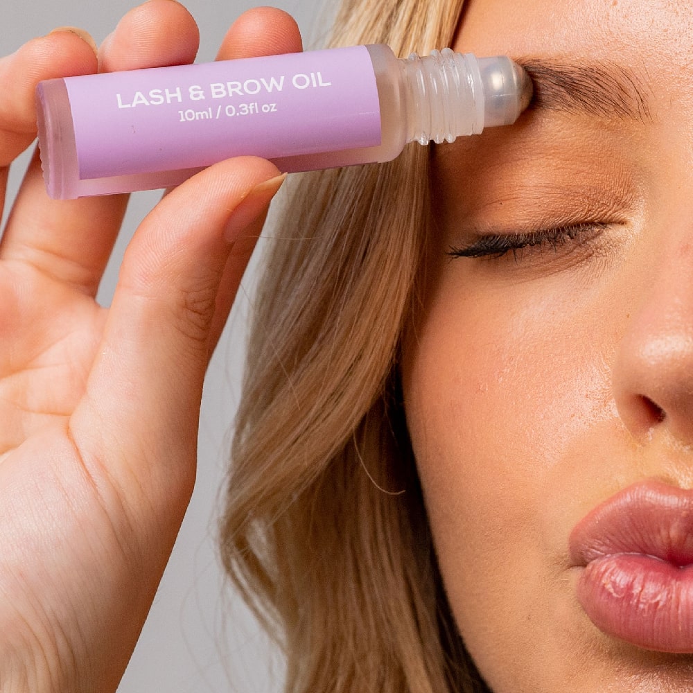 BodyBlendz Lash and Brow Oil applied to eyebrow using roller for fuller thicker brows and enhanced lash growth