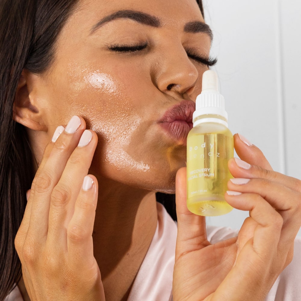BodyBlendz recovery face serum applied to glowing skin, hydrating and brightening facial oil for smooth radiant complexion