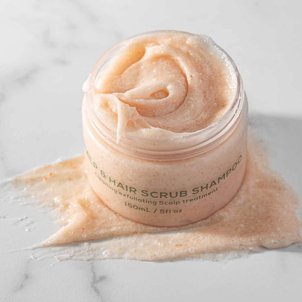 BodyBlendz Scalp and Hair Scrub Shampoo texture close-up showing exfoliating scalp treatment with creamy peach formula in open jar