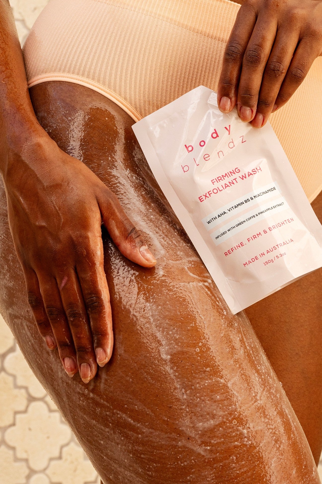 BodyBlendz firming exfoliant wash applied on skin, AHA body cleanser to refine brighten and smooth skin texture
