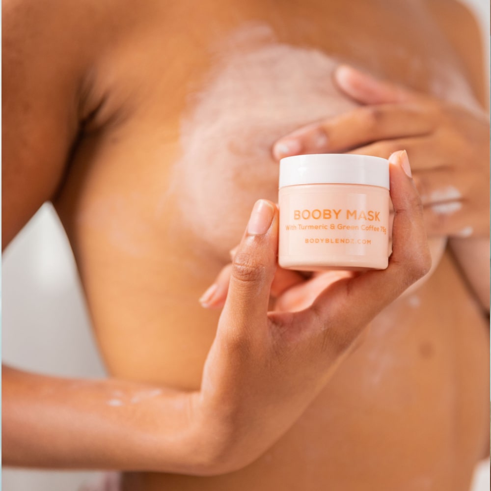 Woman applying BodyBlendz booby mask to chest for firming smoothing and improving skin texture