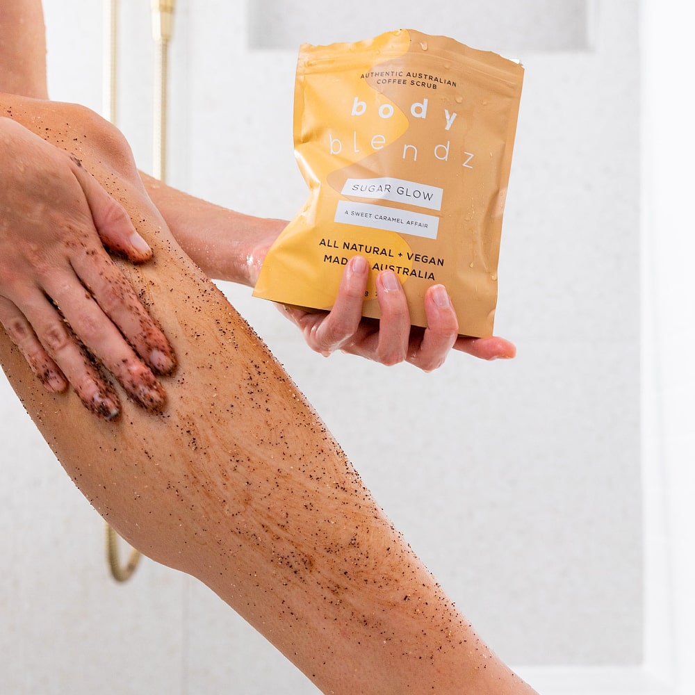 BodyBlendz sugar glow coffee scrub applied on leg, natural exfoliating body scrub for smoother softer glowing skin