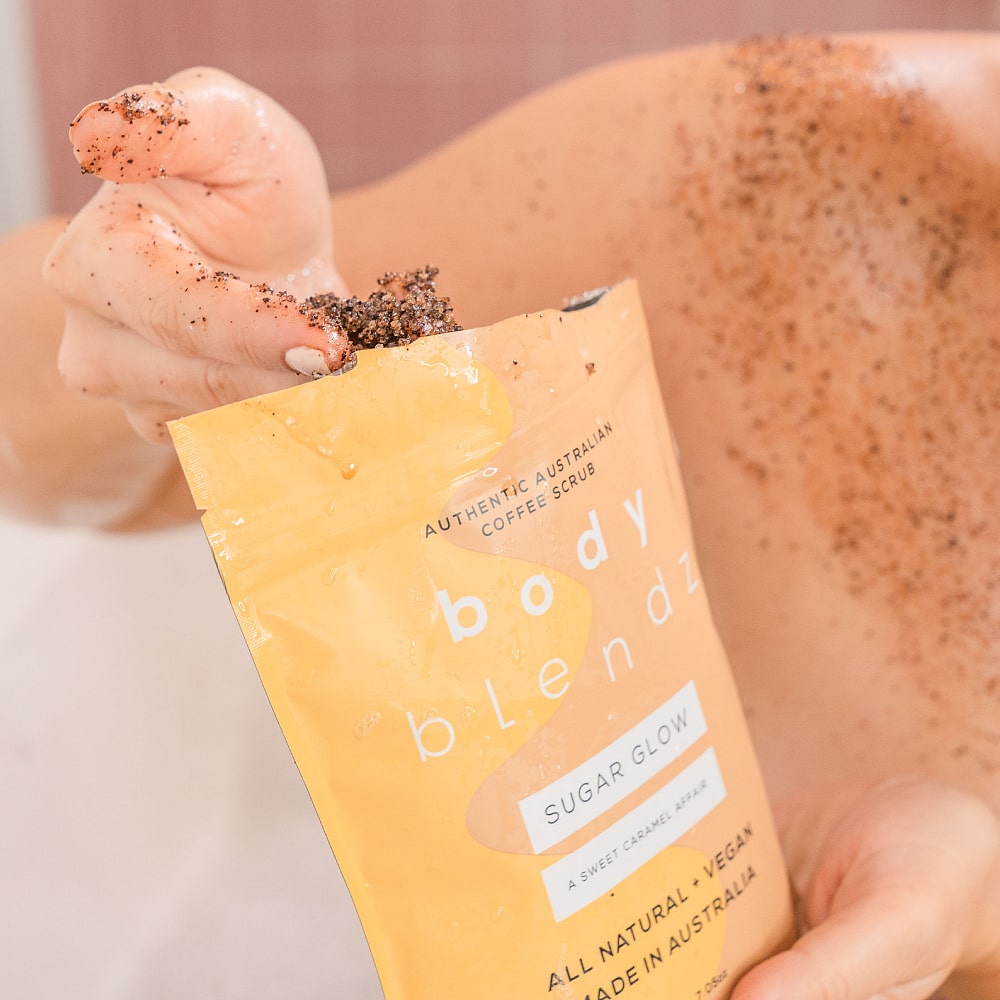 BodyBlendz sugar glow coffee scrub texture in hand, natural exfoliating body scrub for smoother softer glowing skin
